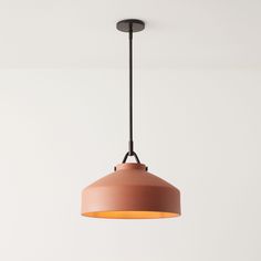 an orange light hanging from a ceiling fixture