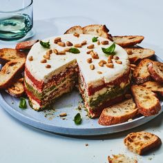 there is a cake that has been cut into pieces and served on a platter