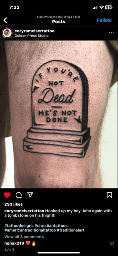 a man's leg with a tombstone tattoo on it