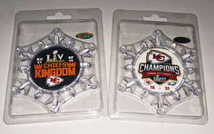 two kansas chiefs super bowl badges are shown in plastic packaging on a white countertop