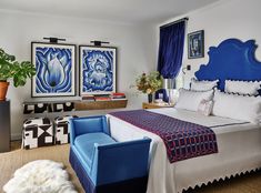 a bedroom with blue and white decor on the walls