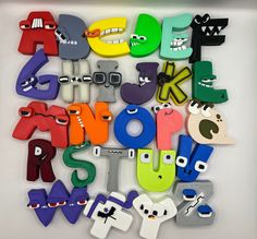 the letters are made up of different shapes and sizes, including one with eyes on each letter