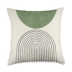 a white pillow with a green circle on the front and black lines on the back