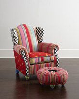 a colorful striped chair sitting on top of a wooden floor