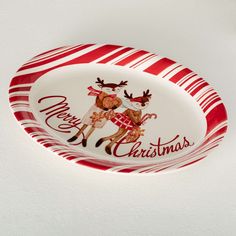 a red and white plate with a reindeer on it's side that says merry christmas