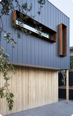 an image of a modern house with wood and metal sidings on the outside wall