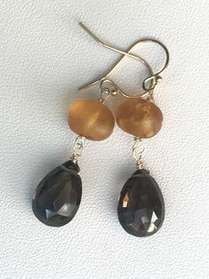 "Raw Amber Brown smoky Quartz 14k gold fill earrings. Natural smoky topaz dangles. Gemstone jewelry. Petite earrings. Gift for woman. Petite earrings. Great for every day and work. I wire wrapped stones to gold fill wires and handmade french hooks to create these lightweight earrings. You will get the same earrings as On the photos, only one pair is available. Each pair of stones is unique and one of a kind, untreated, natural, and hand picked and matched by me. The earrings measure almost 1 1/2 Gold Faceted 14k Gold-filled Earrings, Gold Briolette Earrings Nickel Free, Nickel-free Gold Briolette Earrings, Nickel-free Briolette Yellow Gold Earrings, Nickel-free Yellow Gold Briolette Earrings, Gold Citrine Faceted Earrings, Gold Faceted Citrine Earrings, Elegant Gold Jewelry With Smoky Quartz, Gold Smoky Quartz Gemstone Jewelry