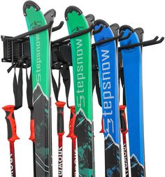 the skis are lined up against the wall for storage and hanging on the rack