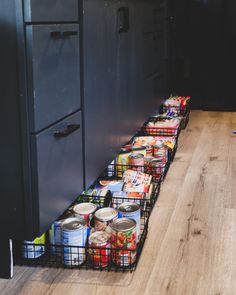 several cans of canned food are lined up on the floor