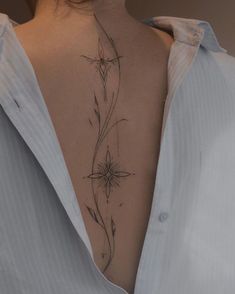 the back of a woman's neck with flowers on it