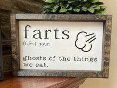 a wooden sign that says, farts fair nom ghosts of the things we eat