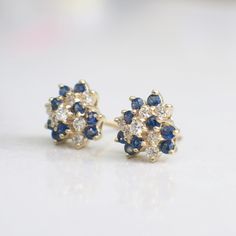 These stunning cluster earrings are made with bright white diamonds and deep blue sapphire gemstones. The vintage clusters are 14k yellow gold and made with threaded backs. These earrings THE perfect gift! Metal: 14K Yellow Gold Diamonds: .42 CTW, SI1, G-H Sapphires: 2 mm each (18) Approx. 2.34 CTW Width: 10.5 MM **Video can be found here: https://blackmarketllc.com/products/14k-yellow-gold-vintage-diamond-and-sapphire-cluster-stud-earrings For a greater selection of jewelry please visit our web Stud Earrings Diamond, Art Deco Diamond Rings, Vintage Diamond Rings, Earrings Diamond, White Gold Diamond Rings, Alternative Engagement Rings, Art Deco Diamond, Sapphire Earrings, Yellow Gold Earring