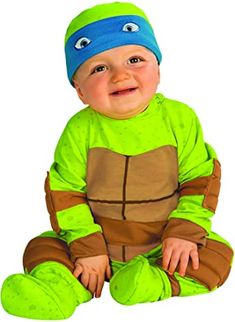 a baby dressed in a teenage mutant costume