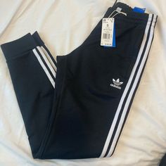 Brand New Adidas Joggers. Slim Fit, Tapered Bottoms. Fitted Black Joggers For Spring, Casual Black Joggers With Side Stripes, Black Cotton Joggers With Three Stripes, Adidas Black Joggers With Three Stripes, Adidas Black Joggers With Side Stripes, Adidas Black Three Stripes Joggers, Black Joggers With Three Stripes, Black Cotton Sweatpants With Three Stripes Branding, Casual Fitted Sweatpants With Three Stripes