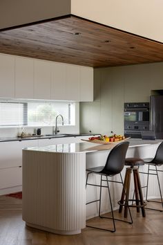 the kitchen is clean and ready to be used as a breakfast bar or for entertaining