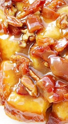 a close up of food on a plate with sauce and nuts in the middle,