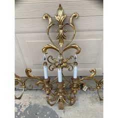 a gold chandelier with three candles on it