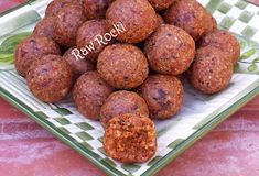 a plate filled with meatballs sitting on top of a table