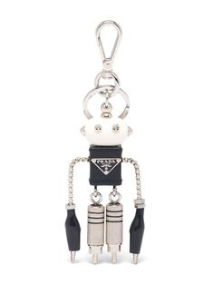 a keychain with two keys attached to it and an object in the shape of a robot