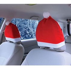 two santa hats sitting in the back seat of a car