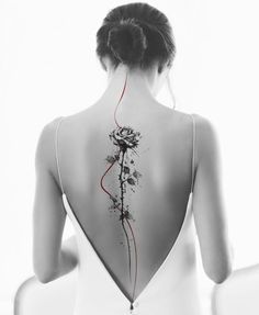 the back of a woman's body with flowers on it