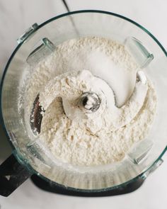 a food processor with flour in it on a table