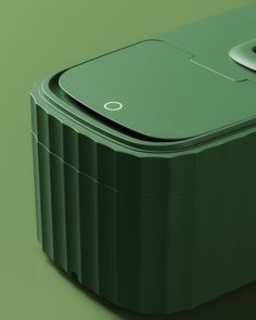 a green portable cooler sitting on top of a table next to a white object in the background