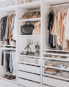 an organized closet with clothes, shoes and handbags on shelve shelves in white