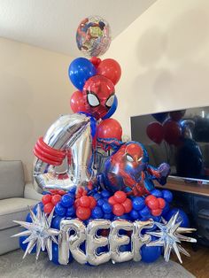 a spiderman balloon centerpiece on top of a table