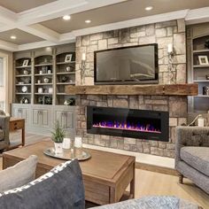 a living room filled with furniture and a flat screen tv mounted on the wall above a fire place