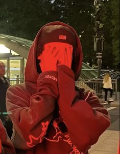 a person in a red hoodie is on the phone