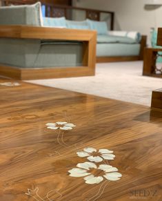 a wooden table with white flowers painted on it