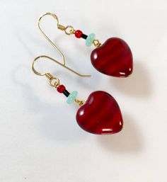 "Vintage Red Heart Earrings, Vintage Ruby Red Heart Earrings, Red Heart Earrings, Red Satin Glass Heart Earrings, Lucy Isaacs This lovely pair of earrings would make a beautiful gift for Valentines Day! The red heart measures 1/2\" x 1/2\" in size and is accented by a black jet tube beads, a greenish blue Czech glass rondel and a deep red round bead. The Heart dangles from 14k gold filled ear wires and have an overall length of 1 1/2\". There's a multi heart necklace to match and also a pendant February Jewelry, Valentine Jewelry, Jewelry Making Business, Red Heart Earrings, Black Jet, Beaded Earrings Diy, Valentines Earrings, Greenish Blue, Holiday Earring