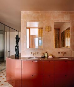 a bathroom with two sinks and mirrors on the wall next to each other in front of a large mirror