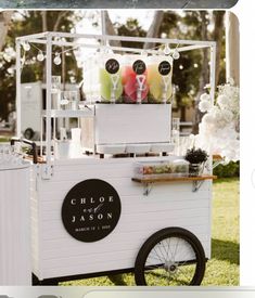 an ice cream cart is decorated with flowers and candles for the wedding guests to enjoy