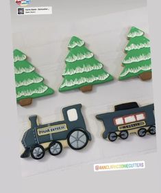 three decorated cookies with train and trees on them