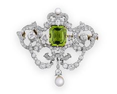 This early 20th-century pendant by Tiffany & Co. features a mesmerizing emerald-cut peridot weighing 5.50 carats embellished with 120 Old European-cut diamonds totaling 3.75 carats. The elegant pendant also features two lustrous pearls set in 18K gold and platinum. Embodying Belle Époque beauty and romance, this stunning piece also doubles an elegant brooch for a variety of styling options. Circa 1900Marked "Tiffany & Co."1 4/5" wide x 1 3/4" length Elegant Brooch, Ruby And Diamond Necklace, Natural Pearl Earrings, Black Opal Ring, Edwardian Jewelry, Peridot Pendant, Cameo Jewelry, Diamond Brooch, Elegant Pendant