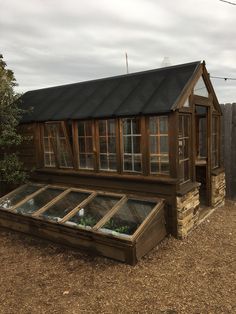 a small wooden house sitting on top of a dirt field