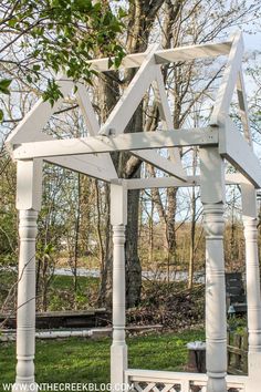 a white wooden structure sitting in the grass