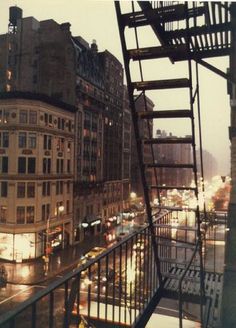 a fire escape in the middle of a city at night