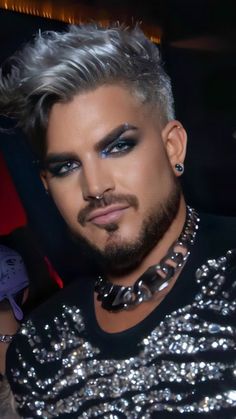 a close up of a person wearing a shirt and tie with silver glitter on it