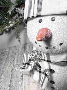 a snowman with a hat and scarf around it's neck