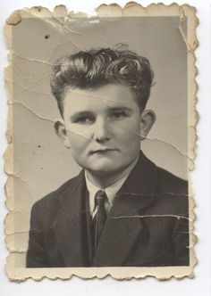 an old black and white photo of a young man