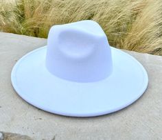 ATLANTA® - WIDE BRIM FEDORA - WHITE Introducing our new Atlanta® line of unisex fedoras, which feature a highly requested extra-large brim compared to the traditional fedora style Handcrafted from a blend of wool and polyester materials Adjustable inner-headband to ensure the proper fit Features a wider 3.75" brim Available in sizes: Medium 56-58cm and Large 58-60cm. FREE shipping on every order Packaged with care - unlike the competitors, our hats are shipped in an innovative inflated package t Casual White Fedora Felt Hat, Casual White Felt Hat With Curved Brim, White Flat Brim Casual Felt Hat, White Casual Felt Hat With Flat Brim, Casual White Felt Hat With Flat Brim, Winter White Wide Brim Fedora, White Wide Brim Felt Hat For Beach, Casual White Fedora For Fall, White Beach Hat For Fall