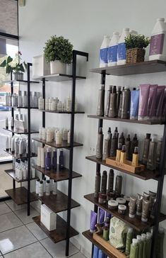 the inside of a store with shelves filled with bottles and soaps on it's sides