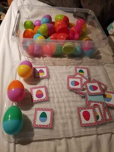 a table topped with lots of different colored balloons and matching cards on top of it