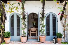 an outdoor patio with potted plants and doors