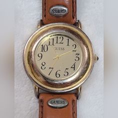 Vintage 90s Guess Women's Gold Tone Watch On Tan Leather Band.  This watch is used and has scratches and wear present.  Heavy wear present to band. 90s Women, Guess Vintage, Women Wrist Watch, Wrist Watches, Leather Band, Tan Leather, Womens Watches, Vintage 90s, Wrist Watch