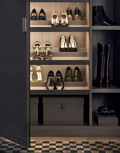 there are many pairs of shoes on the shelves next to each other in this walk - in closet