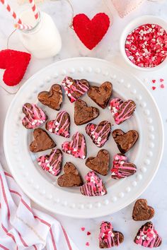 heart shaped chocolates on a plate with pink and white sprinkles